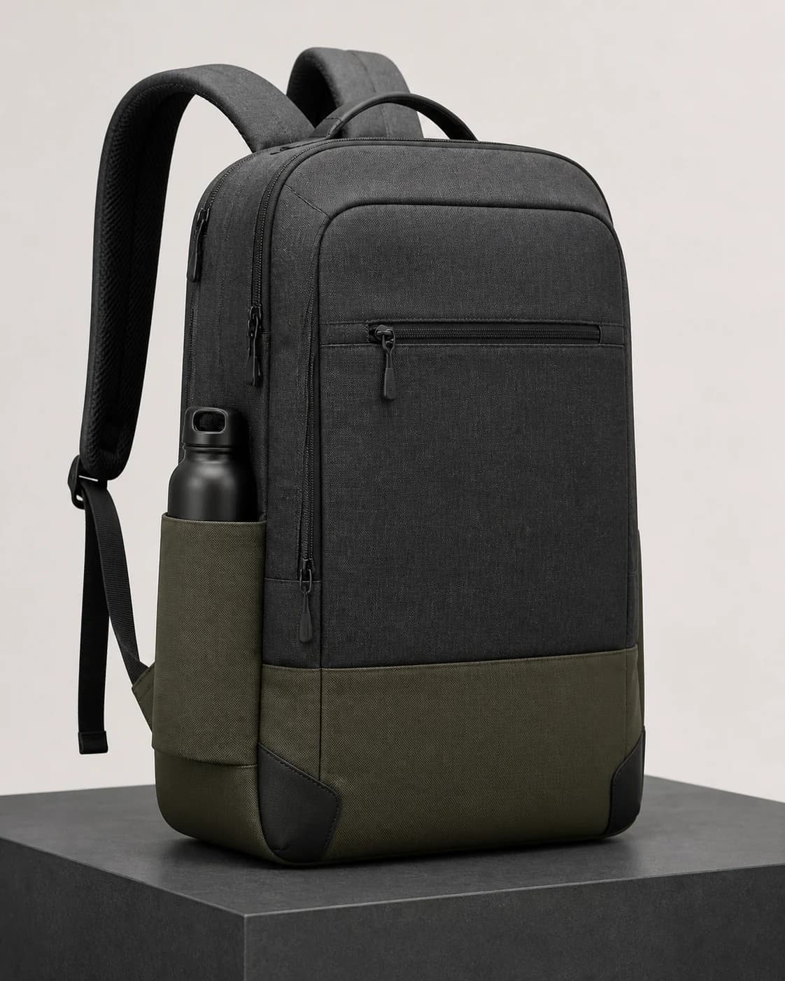 AI concept of an unbranded graphite and forest-green laptop backpack.