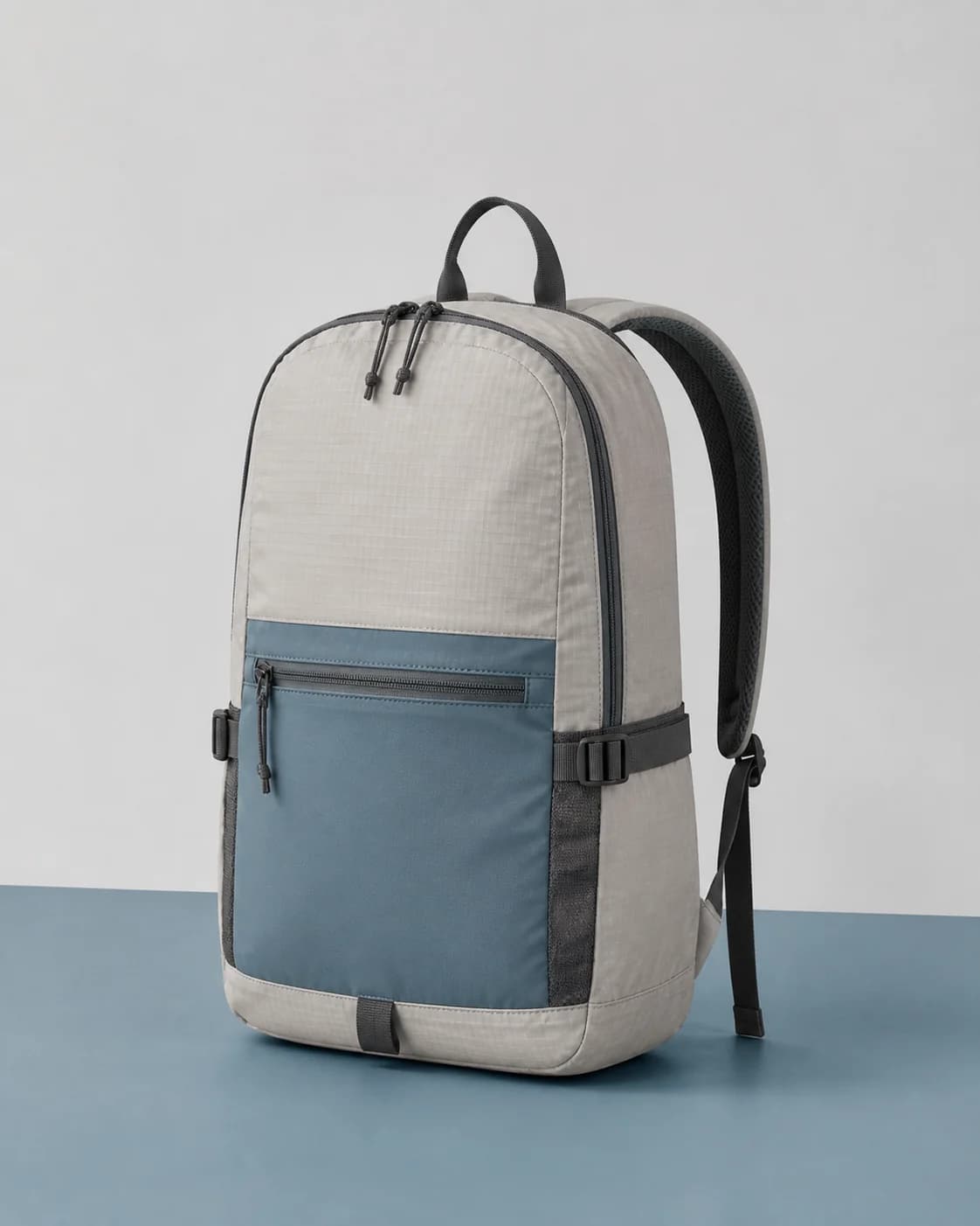 AI concept of an unbranded light-gray and steel-blue lifestyle backpack.