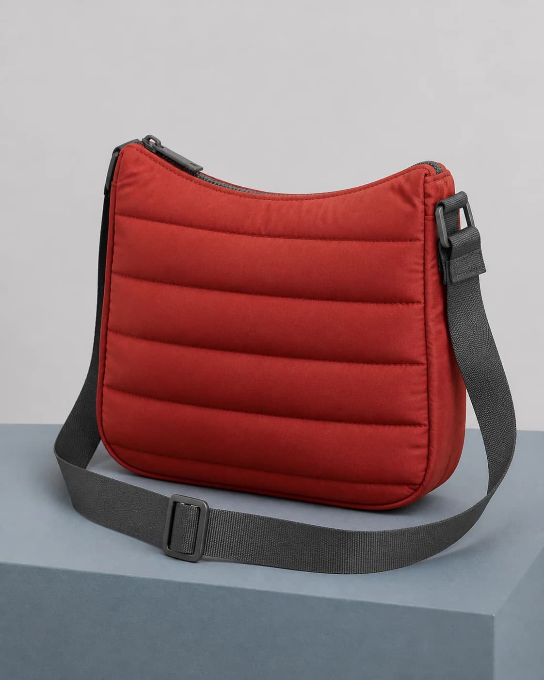AI concept of an unbranded oxide-red channel-quilted shoulder bag.